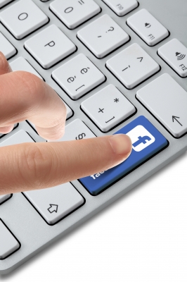Finger pushing Facebook button